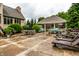 Inviting backyard featuring outdoor dining, a waterfall, and a covered outdoor kitchen at 13346 W Sherbern Dr, Carmel, IN 46032