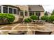 An inviting backyard features a stone patio with an outdoor dining area at 13346 W Sherbern Dr, Carmel, IN 46032