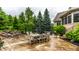 Expansive backyard patio with outdoor dining, a waterfall feature, and lush landscaping at 13346 W Sherbern Dr, Carmel, IN 46032