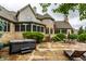 Spacious backyard with a hot tub, patio, dining area, and beautifully landscaped garden at 13346 W Sherbern Dr, Carmel, IN 46032