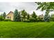 Spacious backyard features lush lawn and mature landscaping, offering privacy and curb appeal at 13346 W Sherbern Dr, Carmel, IN 46032