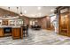 Finished basement area showcases bar, dining area, wood style floors, and unique decorative touches at 13346 W Sherbern Dr, Carmel, IN 46032