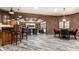 Finished basement with a bar, exposed brick, and comfortable lounge area at 13346 W Sherbern Dr, Carmel, IN 46032