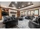 Finished basement with a stone fireplace, leather seating, and elegant area rug at 13346 W Sherbern Dr, Carmel, IN 46032