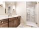 Bathroom featuring a wood vanity with white countertop and a marble shower with glass door at 13346 W Sherbern Dr, Carmel, IN 46032