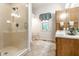 Modern bathroom featuring a glass-enclosed shower and updated vanity at 13346 W Sherbern Dr, Carmel, IN 46032