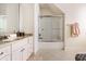 Bright bathroom featuring a vanity with granite countertop and a glass enclosed shower with chrome trim at 13346 W Sherbern Dr, Carmel, IN 46032