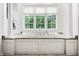Bright bathroom featuring a soaking tub, marble countertop, and garden view at 13346 W Sherbern Dr, Carmel, IN 46032