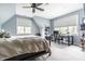 Bedroom featuring two large windows with blinds, a ceiling fan, and a dark metal bed frame at 13346 W Sherbern Dr, Carmel, IN 46032