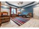 Spacious bedroom with two beds, a ceiling fan, and a blue accent wall with white horizontal stripes at 13346 W Sherbern Dr, Carmel, IN 46032
