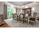 Formal dining room with elegant chairs, large window, and custom built-in cabinet at 13346 W Sherbern Dr, Carmel, IN 46032