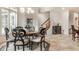 Elegant dining room with chandelier, wood table and seating, and large window at 13346 W Sherbern Dr, Carmel, IN 46032
