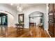 Grand foyer with hardwood floors, arched doorways, and views of the game room at 13346 W Sherbern Dr, Carmel, IN 46032