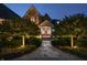 Elegant home at twilight with lit walkway leading to a wood-trimmed front door at 13346 W Sherbern Dr, Carmel, IN 46032