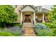 Charming front entrance features beautiful landscaping and a classic wood door at 13346 W Sherbern Dr, Carmel, IN 46032