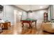 Spacious game room with a pool table, hardwood floors, and elegant decor at 13346 W Sherbern Dr, Carmel, IN 46032