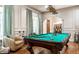 Well-lit game room features a classic pool table and comfortable seating at 13346 W Sherbern Dr, Carmel, IN 46032