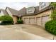 An attached three-car garage, complementing a brick exterior and spacious driveway at 13346 W Sherbern Dr, Carmel, IN 46032