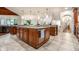 Gourmet kitchen boasts a large island with granite counters and custom cabinetry at 13346 W Sherbern Dr, Carmel, IN 46032