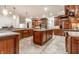 Expansive kitchen boasts granite countertops, wood cabinets, double sinks, and tiled floor at 13346 W Sherbern Dr, Carmel, IN 46032