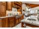 Well-equipped kitchen with granite countertops, stainless steel appliances, and custom cabinets at 13346 W Sherbern Dr, Carmel, IN 46032