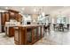 Spacious kitchen with granite countertops, wood cabinetry, and an inviting dining nook at 13346 W Sherbern Dr, Carmel, IN 46032