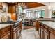Gourmet kitchen with stainless steel appliances, stone countertops, and wood cabinets at 13346 W Sherbern Dr, Carmel, IN 46032