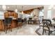 Open kitchen featuring a stone fireplace and breakfast bar with barstool seating at 13346 W Sherbern Dr, Carmel, IN 46032