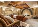 Relaxing entertainment room with cloud ceiling, lounge seating, unique architecture, and stone walls at 13346 W Sherbern Dr, Carmel, IN 46032