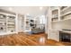 Cozy living room featuring built in bookshelves, wood floors, neutral paint, and natural lighting at 13346 W Sherbern Dr, Carmel, IN 46032