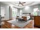 Serene main bedroom with hardwood floors, tray ceiling, and abundant natural light at 13346 W Sherbern Dr, Carmel, IN 46032