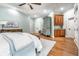 Spacious main bedroom boasting light blue walls, hardwood flooring, and an elegant ceiling fan at 13346 W Sherbern Dr, Carmel, IN 46032