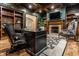 Stylish office boasts wood details, fireplace, a patterned rug, and cozy seating at 13346 W Sherbern Dr, Carmel, IN 46032