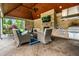 Charming covered outdoor kitchen with fireplace, TV, stainless steel appliances, and seating at 13346 W Sherbern Dr, Carmel, IN 46032