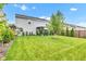 Spacious backyard with a lush lawn, privacy fence, and a covered patio ideal for outdoor gatherings at 13844 N Cardonia Dr, Camby, IN 46113