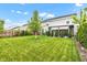 Expansive backyard featuring a well-maintained lawn, mature trees and a cozy covered patio for relaxation at 13844 N Cardonia Dr, Camby, IN 46113