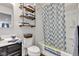 Cozy bathroom featuring a shower and bathtub with stylish patterned shower curtain and rustic wooden shelving at 13844 N Cardonia Dr, Camby, IN 46113