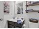 Charming bathroom featuring a vanity with a dark wood cabinet and decorative shelves with towels and decor at 13844 N Cardonia Dr, Camby, IN 46113