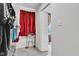 Spacious closet featuring a window with red curtains and convenient walker for accessibility at 13844 N Cardonia Dr, Camby, IN 46113