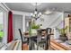 Cozy dining room with modern chandelier, table seating four, and access to a staircase at 13844 N Cardonia Dr, Camby, IN 46113