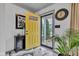Welcoming foyer featuring elegant marble floors, a bright yellow door, and stylish decorative accents at 13844 N Cardonia Dr, Camby, IN 46113