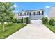Inviting two-story home with a vibrant yellow door, attached two-car garage, and landscaped front yard at 13844 N Cardonia Dr, Camby, IN 46113