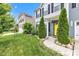 Charming home with a yellow front door, well-manicured lawn, and thoughtfully landscaped front yard at 13844 N Cardonia Dr, Camby, IN 46113