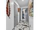 Hallway with striking marble-patterned floors and decorative wall art at 13844 N Cardonia Dr, Camby, IN 46113