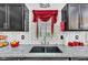 The renovated kitchen features granite countertops, custom cabinets, and a modern sink at 13844 N Cardonia Dr, Camby, IN 46113