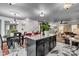 Open concept kitchen with stainless steel appliances, granite counters, and breakfast bar seating at 13844 N Cardonia Dr, Camby, IN 46113