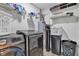 Functional laundry room with shelving above the washer and dryer providing storage for detergents and linens at 13844 N Cardonia Dr, Camby, IN 46113