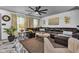 Elegant living room featuring a large leather sectional, chic decor, and ample natural light from the windows at 13844 N Cardonia Dr, Camby, IN 46113