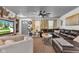 Comfortable living room featuring a leather sofa, ceiling fan, and neutral decor at 13844 N Cardonia Dr, Camby, IN 46113