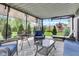 Inviting screened patio with comfortable seating, stylish rug, and views of the landscaped backyard at 13844 N Cardonia Dr, Camby, IN 46113